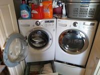 a washer and dryer in a small room with other items on the floor