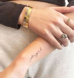 a woman's arm with a small tattoo on the left side of her wrist