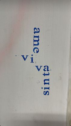 a close up of a metal object with blue writing on the bottom and an upside down view of it