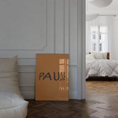 a box sitting on the floor in front of a bed