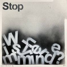 a black and white photo with the words stop written in spray paint