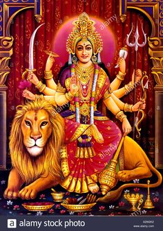 the hindu god sitting on top of a lion with two swords in his hand and holding