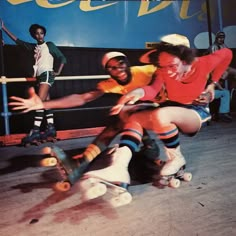 three people are sitting on skateboards in front of a poster