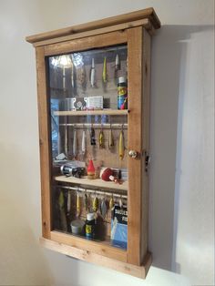 This cabinet has 2 Shelves, and 3 Dowels. Showcase your antique, vintage or everyday Lures, plus your fishing memorabilia in this top-quality Fishing Lure Display cabinet. These are handmade from Western Red Cedar to give that rustic look. Please note, the inside back panel may differ from photos. Comes with Brass Knob, brass hinges and brass lock & key. The door includes a Plexiglas pane.  Hang in Den, Gameroom, Mancave, Office, or Rec room.  Cabinet iinside dimensions measure 16-1/2" wide x 33 Fishing Cabinet, Lure Display, Mancave Office, Fishing Lures Display, Memorabilia Display, Room Cabinet, Brass Knob, Brass Hinges, 2 Shelves