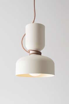 a white light hanging from a ceiling with a brown cord attached to the top of it