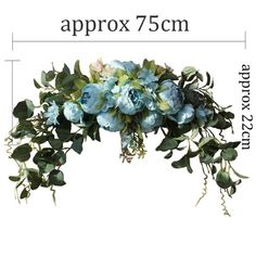 an arrangement of blue flowers and greenery on a white background with the words approx 75cm