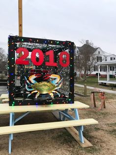 a sign that is sitting on top of a picnic table