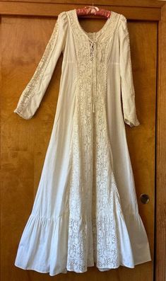 This is a vintage 1970s Gunne Sax dress, worn once as an 8th grade graduation dress in 1973 and has been in storage ever since. 100 percent cotton muslin, handwashable. Please review detailed measurements for an accurate fit. it is in good condition with several small, light spots on the bottom tier of the skirt. there is a small 2" repaired tear near the bottom and slight discoloring on the bodice tie tag size: 11 shoulders: 13" flat measure  bust: 34" waist: 28" shoulder to bottom edge of wris White Lined Cotton Vintage Dress, White Cotton Lined Vintage Dress, White Cotton Vintage Dress With Lining, 1970s Cotton Vintage Dress For Daywear, Vintage Flowy Maxi Dress, Flowy Vintage Maxi Dress For Daywear, Spring Cotton Maxi Dress For Weddings, Cotton Maxi Dress For Spring Wedding, Spring Wedding Cotton Maxi Dress