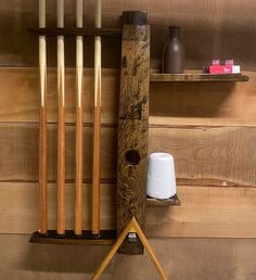 a wooden rack with several different types of crochet hooks and knitting needles on it