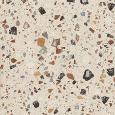 a white floor with brown, blue and black speckles on the top of it