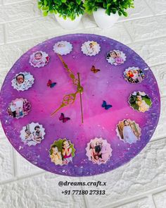 a purple clock with pictures of people on it and a plant next to it in a white room