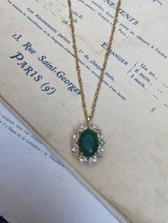 Gold-plated over brass vintage inspired pendant with crystals and a large oval emerald green measuring 2.4 cm 3 cm. Hung on a gold-plated over stainless steel twisted chain measuring 18 inches. Comes in a black velvet cushioned box as seen in last photo. Free of charge. INTERNATIONAL BUYERS please choose the tracking option if you would like your order to be tracked. FREE tracking upgrade with 3 items or more purchased. JEWELLERY CARE please don't wear plated jewellery in the shower, bath or swi Emerald Necklace Vintage, Luxury Oval Pendant Emerald Necklace, Vintage Gold Crystal Necklace, Vintage Gold Plated Necklace With Oval Pendant, Vintage Emerald Necklace With 17 Jewels As A Gift, Vintage Emerald Necklace As A Gift, Vintage Emerald Necklace Gift, Vintage Emerald Necklace For Gift, Vintage Gold Necklace With Emerald