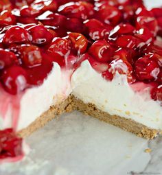 a close up of a dessert with cherries on it's crust and cheesecake crust