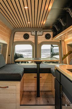 an interior view of a camper with wood paneling and built - in seating