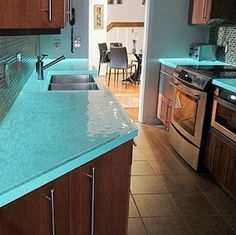 a kitchen with blue counter tops and wooden cabinets