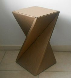 a small wooden table sitting on top of a tile floor next to a white wall