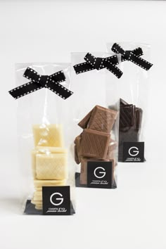 three different types of chocolates in cellophane bags with black bows on them