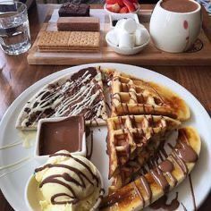 some waffles and ice cream on a white plate