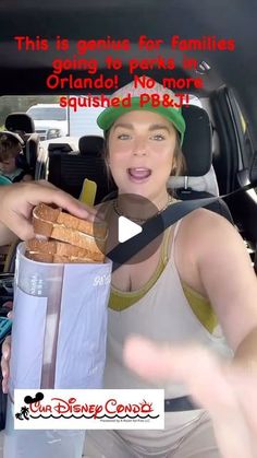 a woman holding a sandwich in the back seat of a car while talking to someone