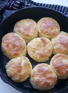 six biscuits in a cast iron skillet ready to be cooked