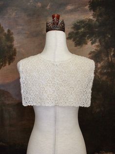 Warm up your historically inspired outfits during the colder months, with this Floral Crochet Folk Shawl / Capelet! Made from ornately patterned knit fabric, this piece can be worn tied around the shoulders, the waist, or simply left untied to drape off your shoulders. Truly a versatile piece that can compliment historical styles from any era!Also available in Black & White! Sizing: One SizeTie Length - 23 Inches / 57.5 CentimetersCape Length - 11 Inches / 27.5 CentimetersCape Width - 15 Inches / 37.5 Centimeters Materials:Cotton Weave Elegant Cream Crochet Top With Crochet Trim, Elegant Cream Crochet Top With Trim, Elegant Cream Crochet Top With Lace Trim, Cream Bohemian Fitted Lace, Cream Crochet Top With Lace Trim, Fitted Beige Crochet Top With Lace Trim, Vintage Cream Lace Crochet Top, Vintage Cream Crochet Top, Vintage Cotton Crochet Trim Top