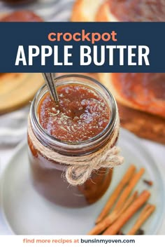 a jar filled with crockpot apple butter sitting on top of a white plate