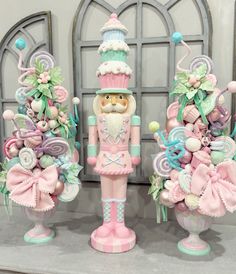 three pink and green nutcrackers are on display