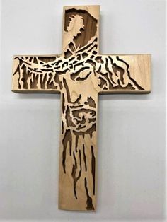 a wooden cross that has been carved into the shape of jesus's face on it