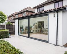 a house with large sliding glass doors on the outside