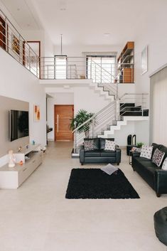 a living room filled with furniture and a stair case