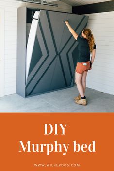 a woman painting the side of a bed with text overlay that reads diy murphy bed