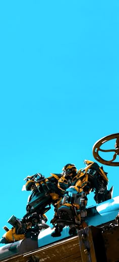 a close up of a metal object on top of a building with a sky in the background