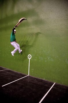 a man jumping in the air with a baseball bat