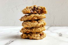 a stack of cookies sitting on top of a white marble counter next to a wall