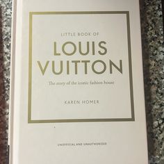 the little book of louis vuitton by karn homer is sitting on a table