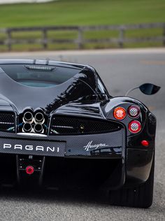 a black sports car driving down the road