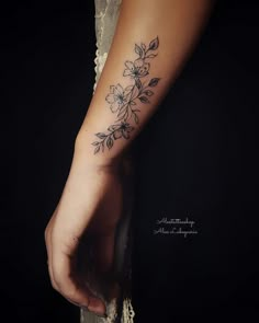 a woman's arm with a flower tattoo on the left side of her body