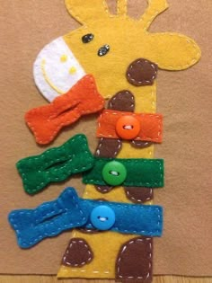 a giraffe made out of felt and buttons