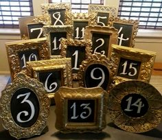 there are many gold frames with numbers in them on the table next to each other