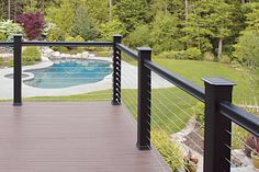 a wooden deck next to a swimming pool