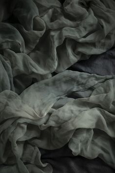 an unmade bed with black and white sheets