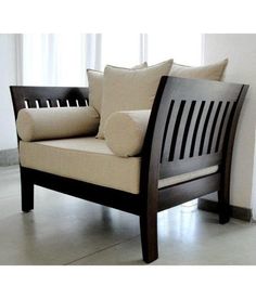 a wooden chair with pillows on it in front of a window and flooring area