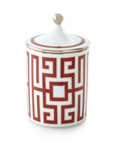 a red and white canister sitting on top of a table