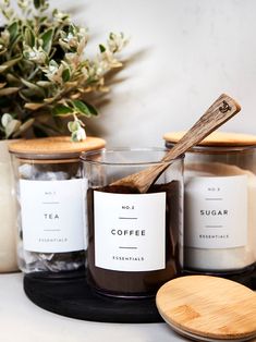 three candles with wooden spoons sitting next to each other