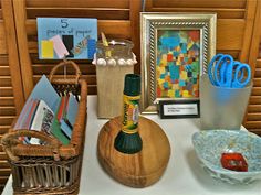 a table topped with lots of art and craft supplies on top of a white counter