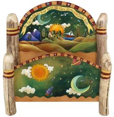 a painted wooden bed frame with an image of the moon, stars and mountains on it