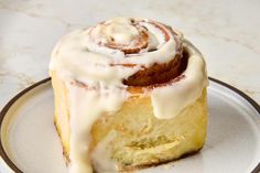 a cinnamon roll with icing on a plate