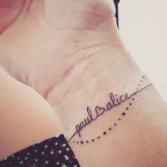 a woman's wrist with a tattoo that reads pauldalice on it