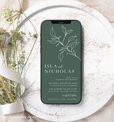 an iphone on a plate next to flowers and a white ribbon with the words, island nicholas