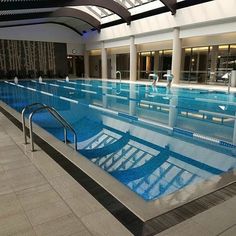 an indoor swimming pool in a large building